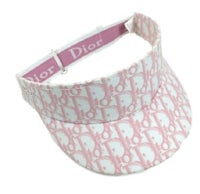 a pink and white visor with a dior logo on it